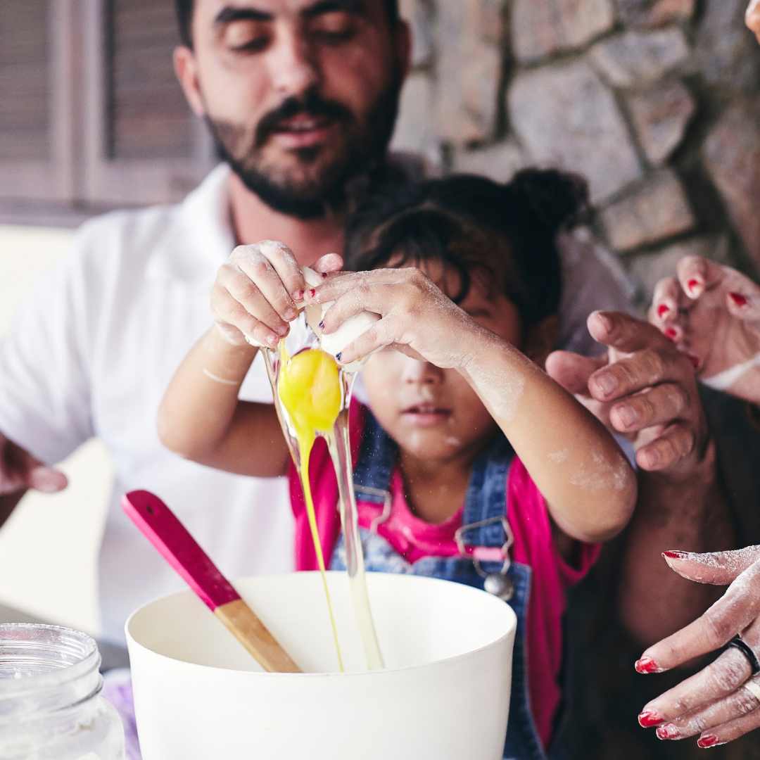 Little girls cooks with her parents - making memories with your kids