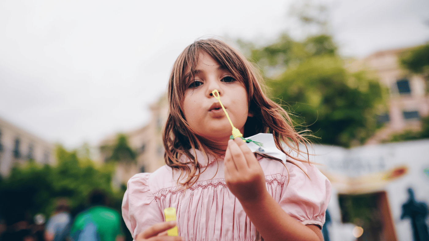 girl blowing balloons 